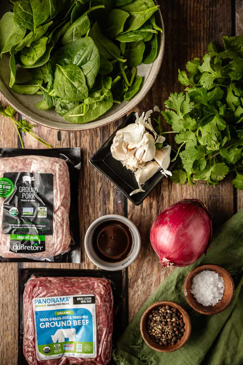 An overview shot of the ingredients needed for Whole30 asian meatballs on a wood background