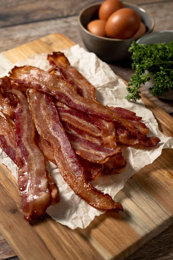 Whole30 crispy bacon on a wood cutting board 