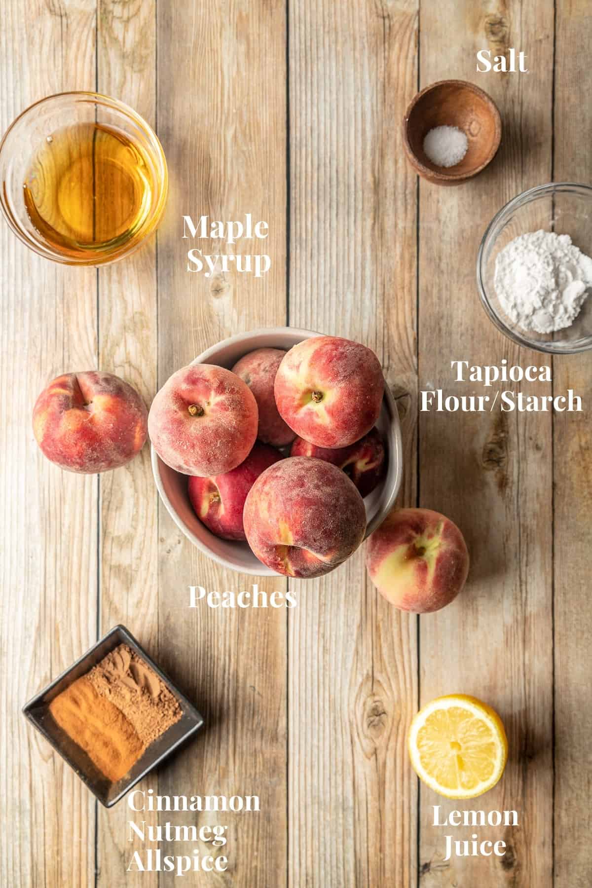 The ingredients needed for peach cobbler filling on a wood background.