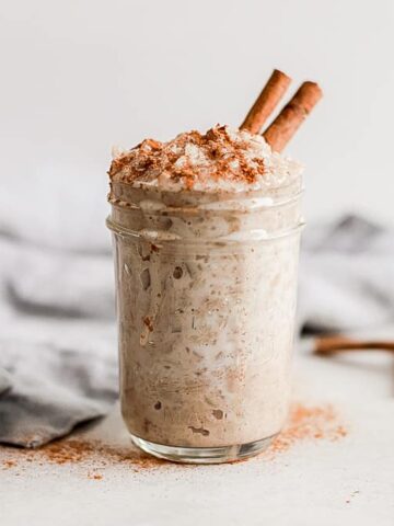 A jar of cauliflower rice pudding topped with cinnamon
