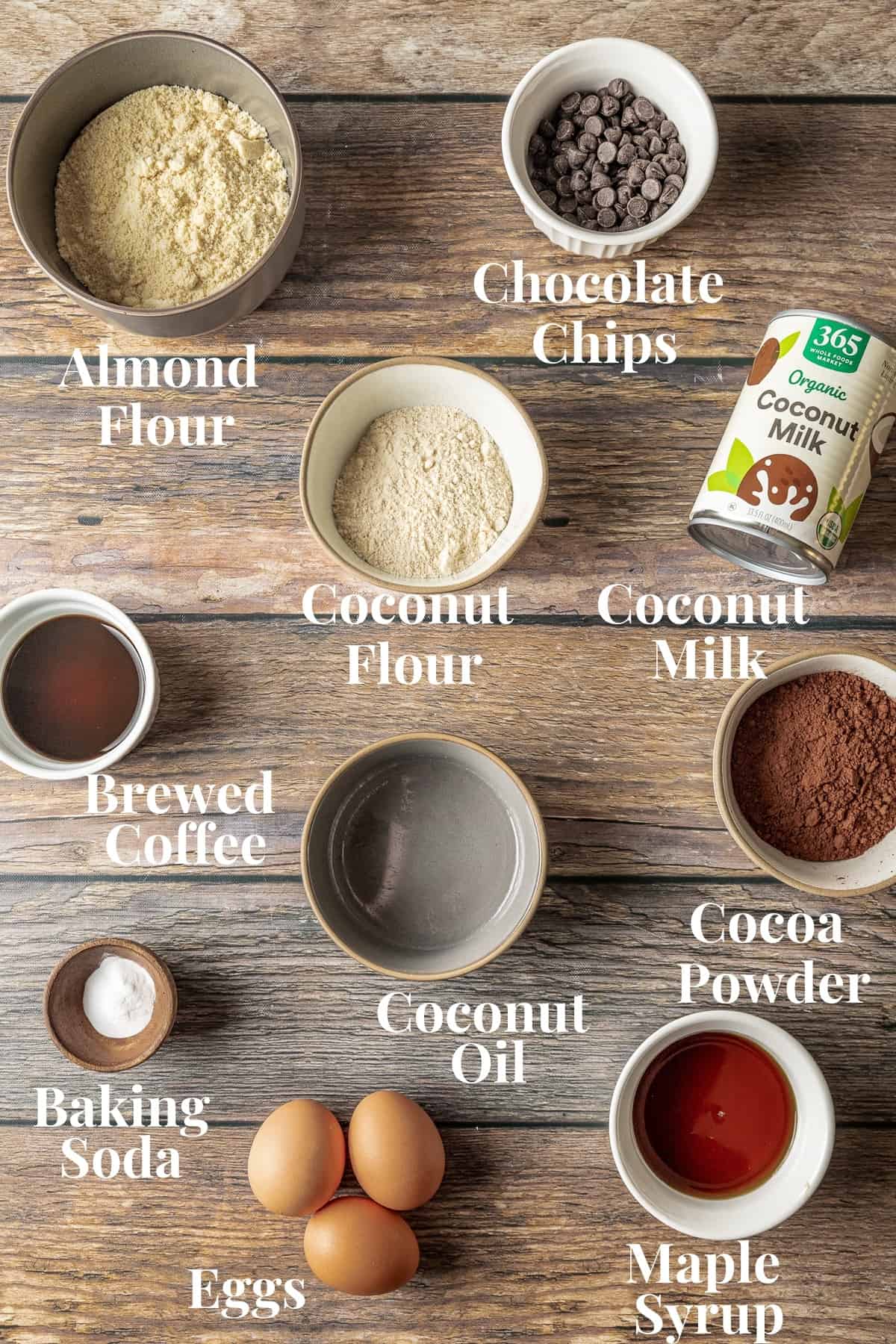 An overview shot of the ingredients needed for gluten free cupcakes on a wood background.