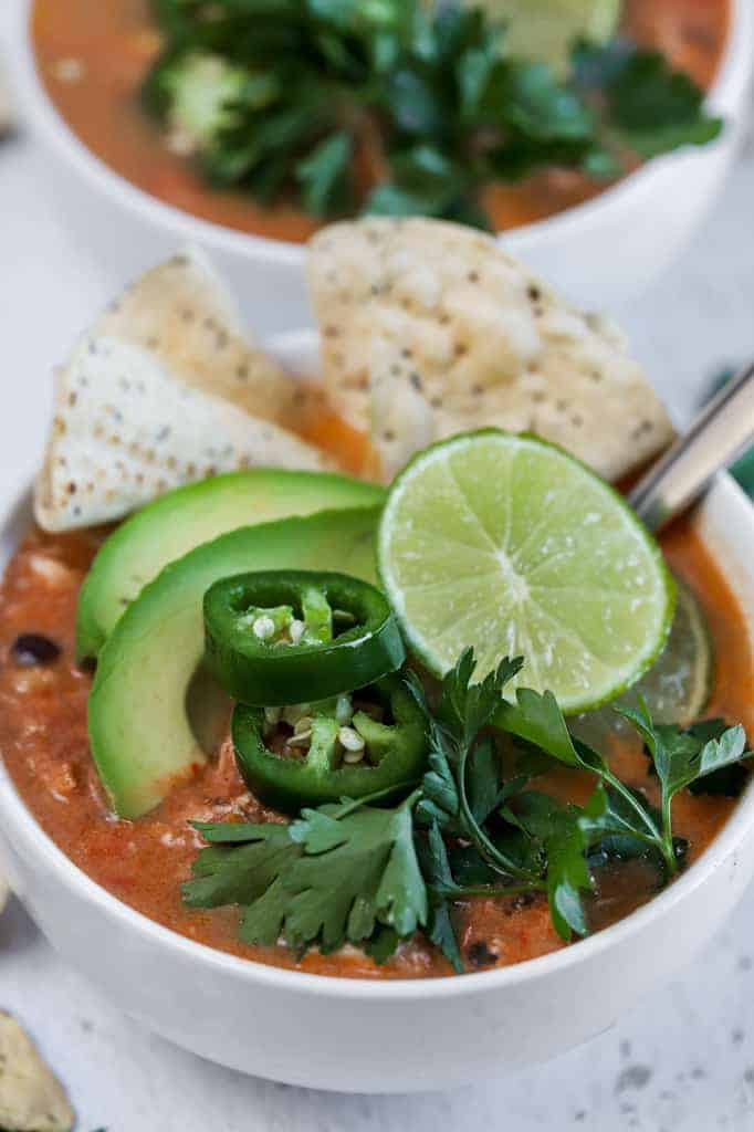 A top view of two bowls of chicken tortilla soup