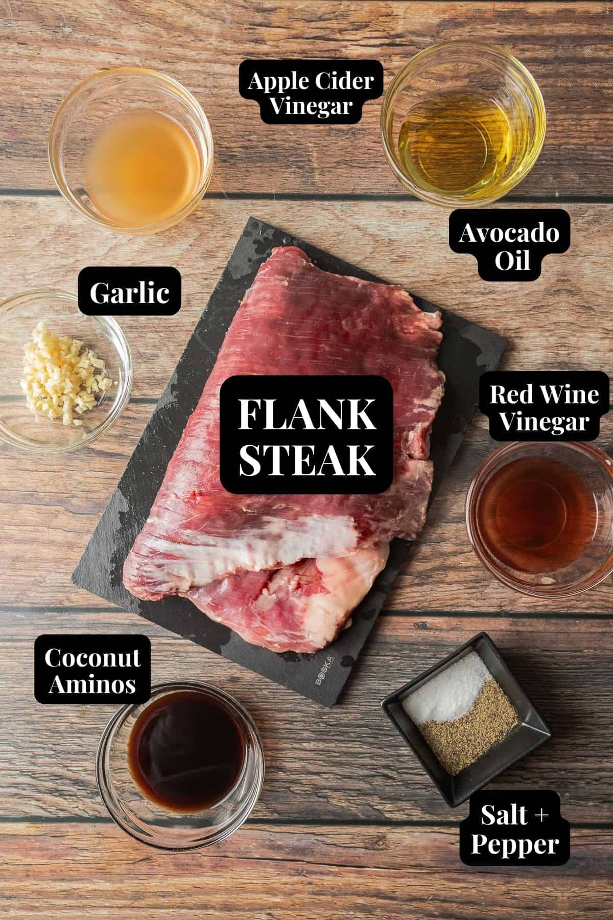 An overview shot of the ingredients needed for traeger smoked flank steak in glass bowls on a wood background.