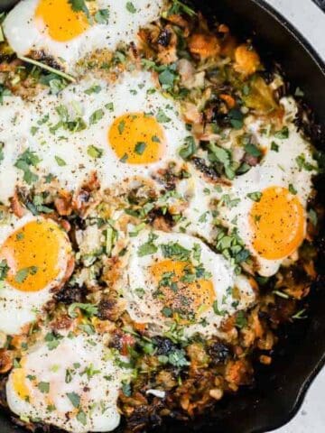 Sweet potato hash browns and eggs in a cast iron skillet