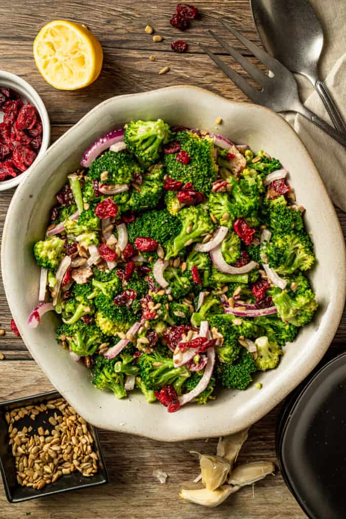 An overview shot of paleo broccoli salad with bacon on a wood background