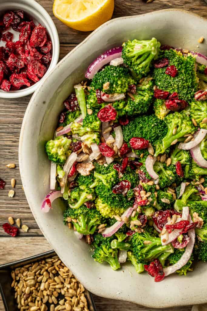An overview shot of paleo broccoli salad with bacon on a wood background