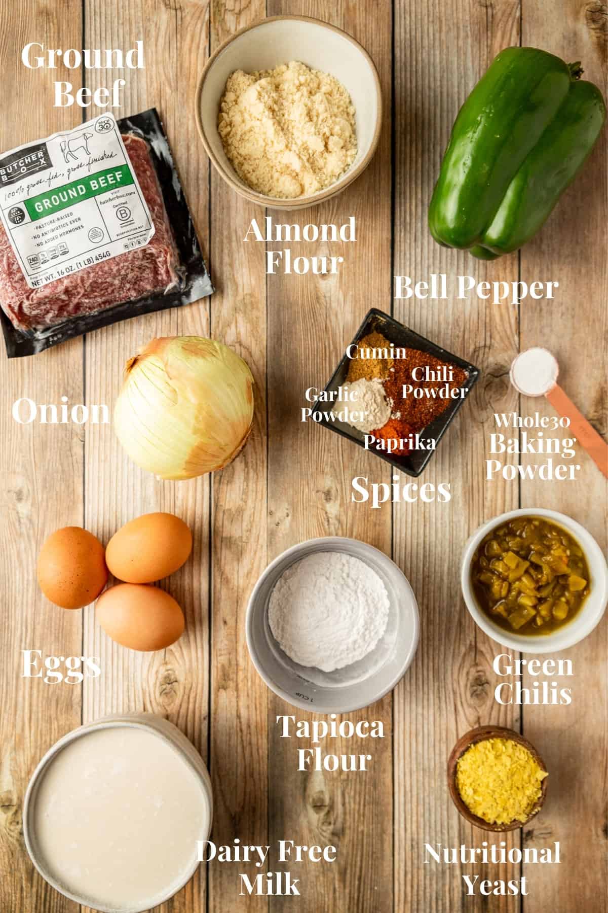 An overview shot of the ingredients needed for taco casserole on a wood background