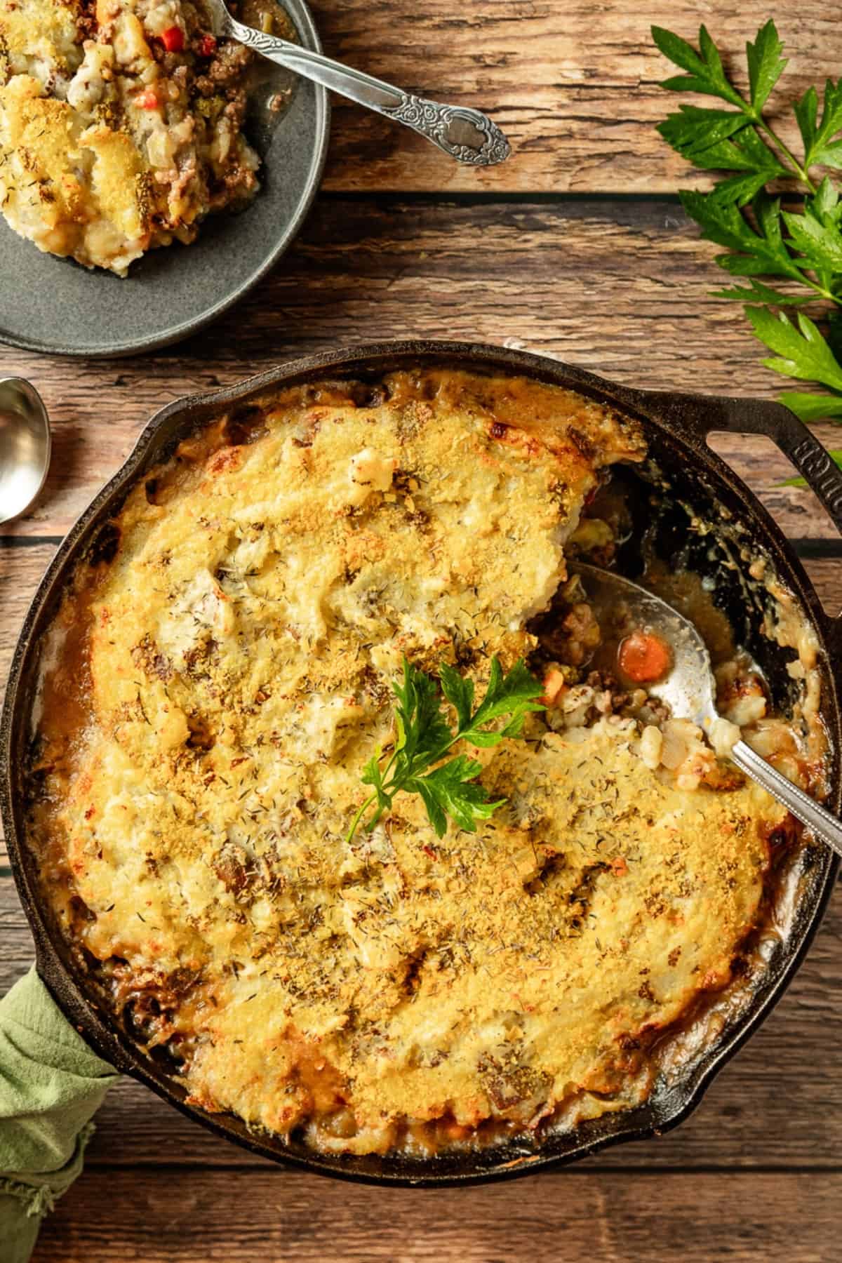 An overview shot of whole30 shepherds pie with a slice removed on a small black plate