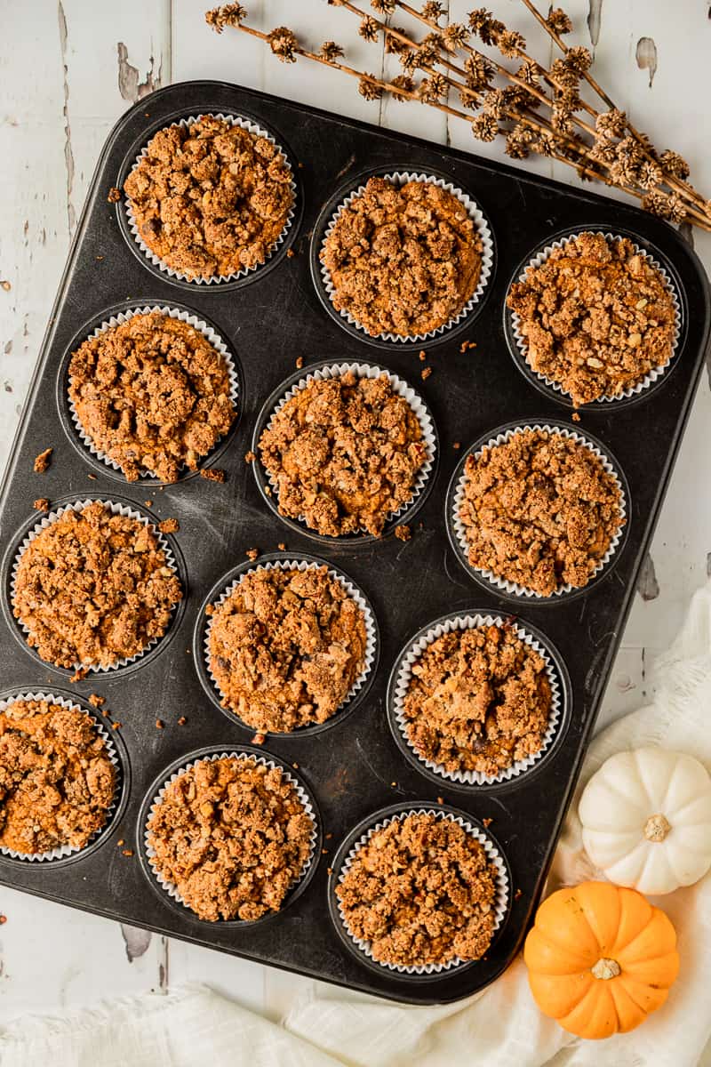 An overhead for of paleo pumpkin muffins in a muffin tin ready to go into the oven