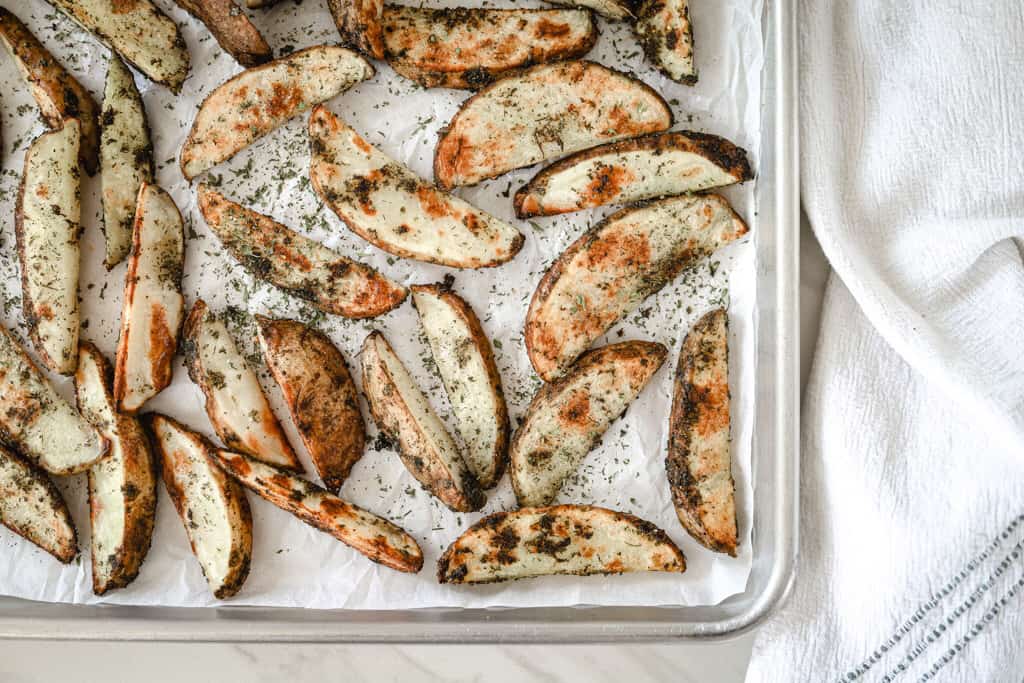 A pan of baked ranch potato wedges