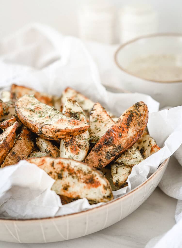 Baked Ranch Potato Wedges with a bowl of ranch