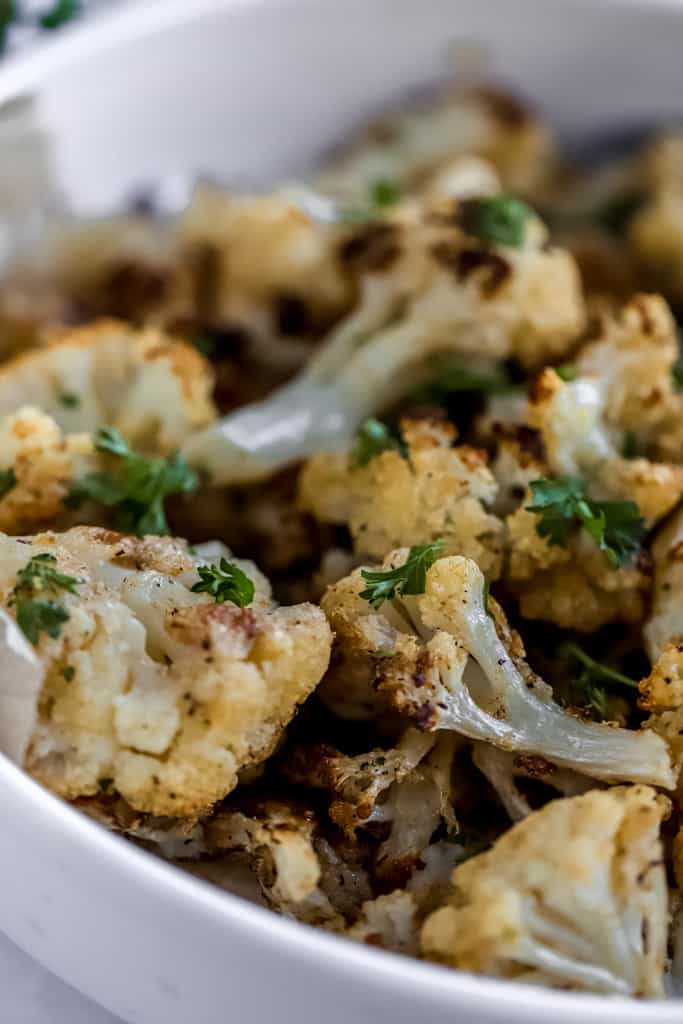 A close up of a bowl of roasted cauliflower