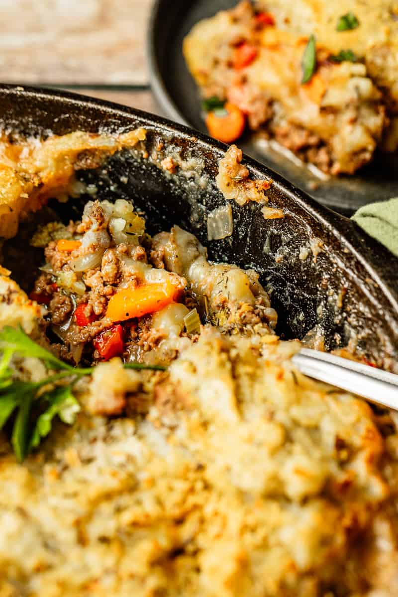 A close up shot of whole30 and paleo Shepherds Pie filling in a cast iron pan 