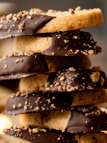 A stack of almond flour shortbread cookies that had been dipping in chocolate.