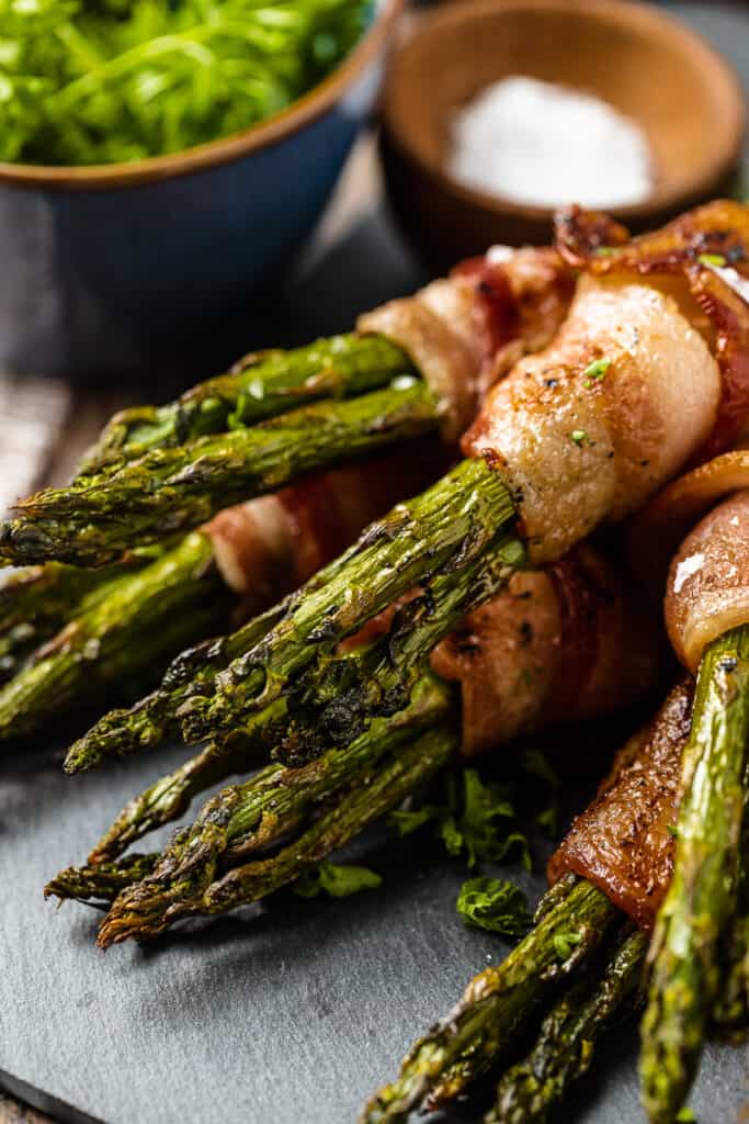 A close up view of bacon wrapped asparagus bundles