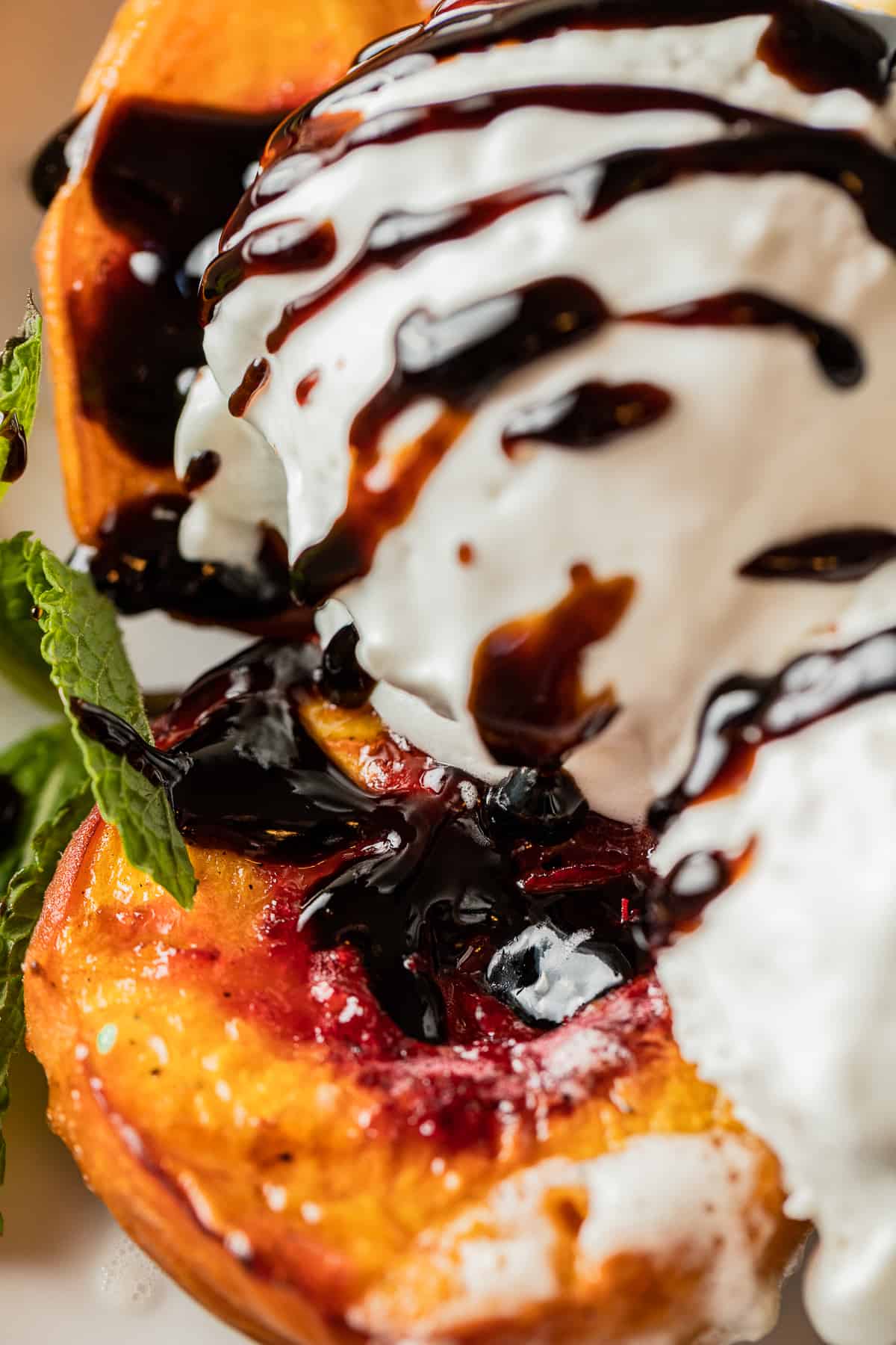Smoked peaches topped with vanilla ice cream and balsamic glaze.