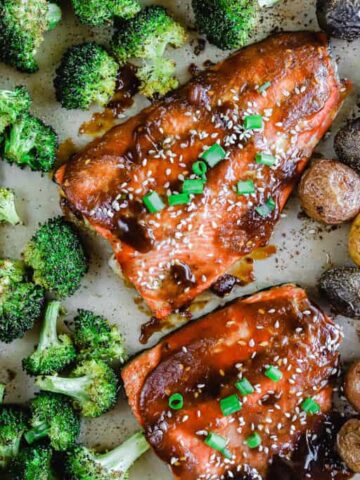 A sheet pan of teriyaki salmon, roasted potatoes, and roasted broccoli.