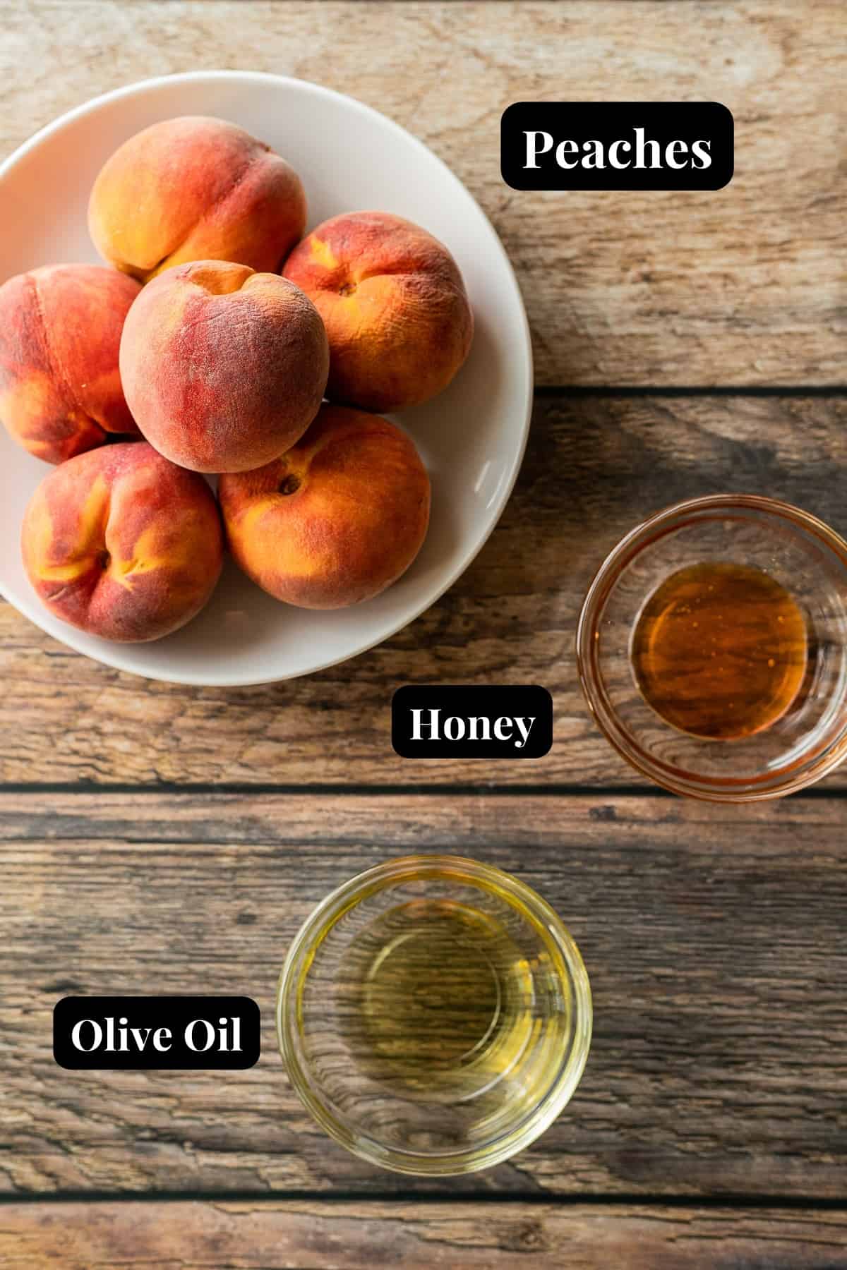 The ingredients needed for grilled peaches on a wood background.