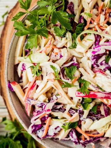 A closeup overview shot of a bowl of Whole30 coleslaw topped with parsley