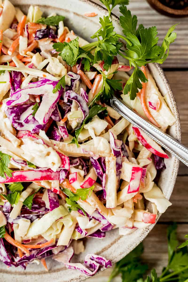 A closeup overview shot of a bowl of Whole30 coleslaw topped with parsley