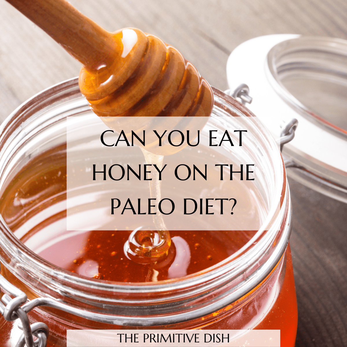 Honey drizzle into a glass jar with the text overlay "Can you eat honey on the paleo diet?"